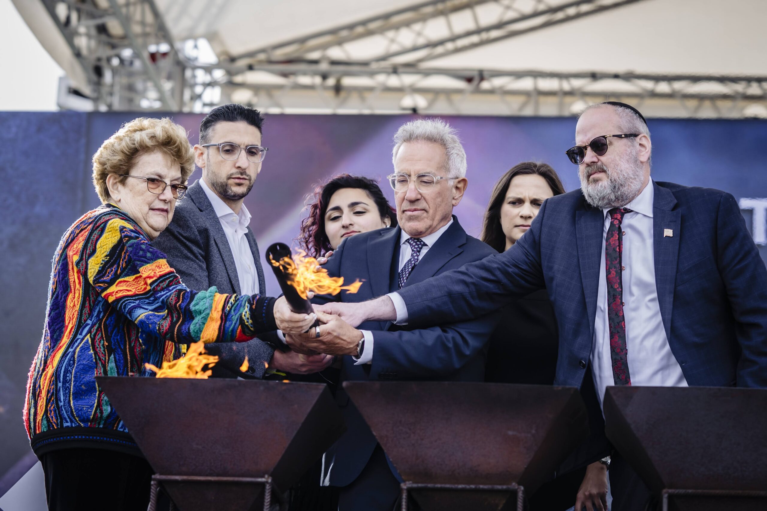 Lighting the torch against antisemitism at the closing ceremony in Birkenau