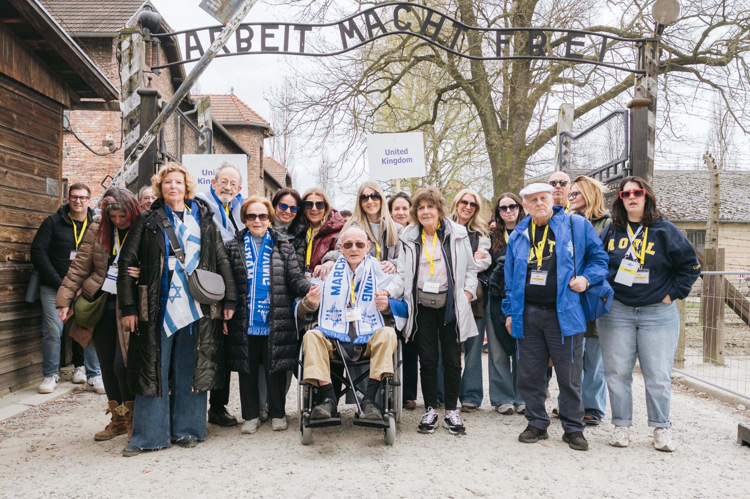 Holocaust survivors from the UK delegation at the gate of Auschwitz