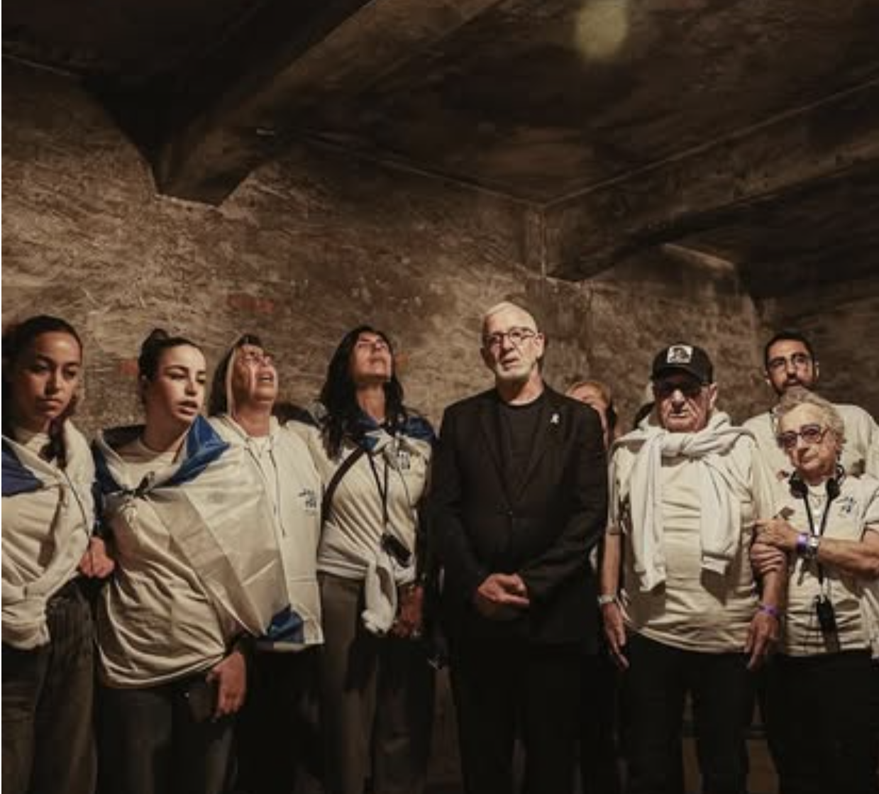 Haim Taib and members of the October 7 delegation in Auschwitz