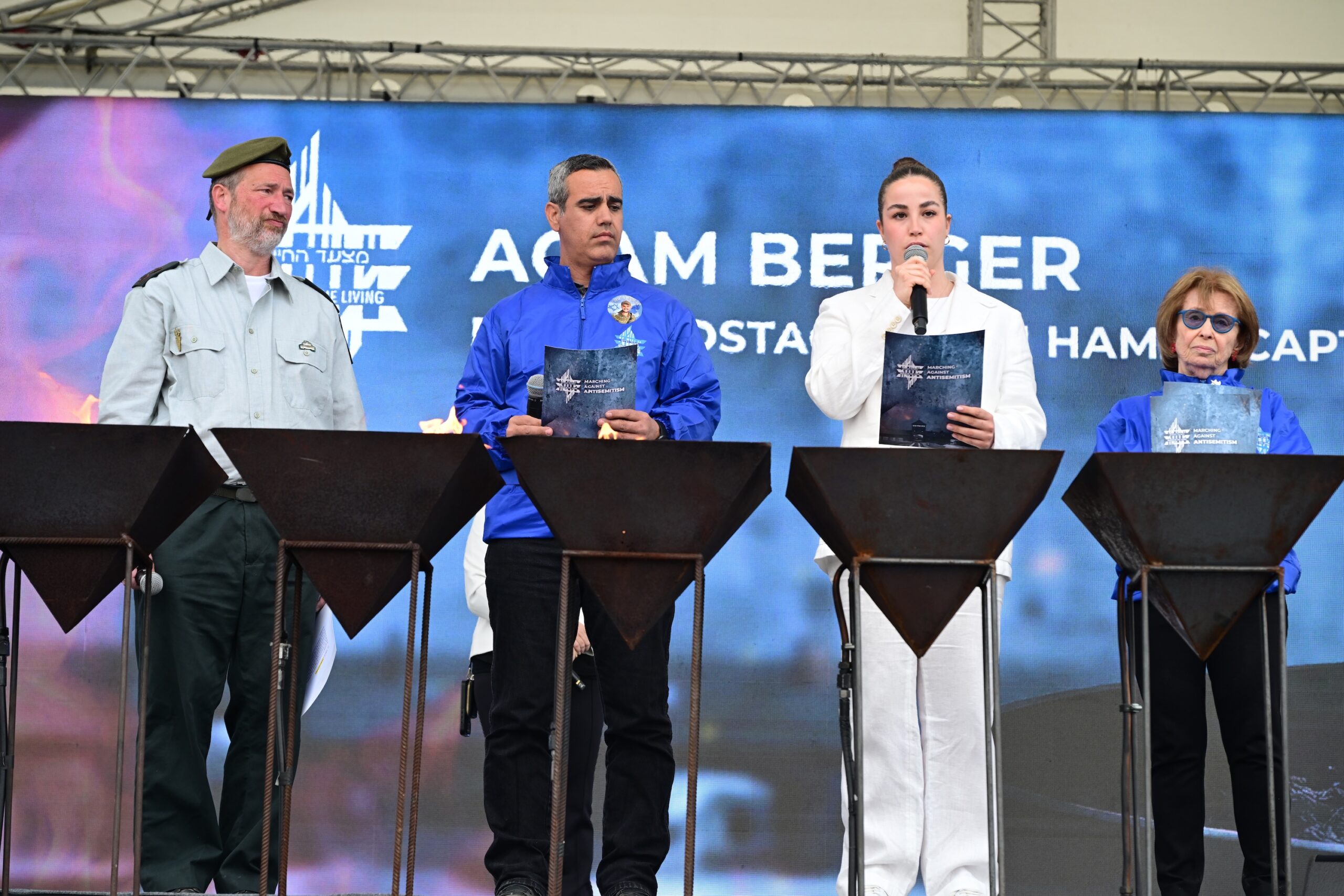 Rabbi Shmuel Slotki, freed hostages Omri Miran and Agam Berger, and Holocaust survivor Irene Shashar at the 2026 March of the Living
