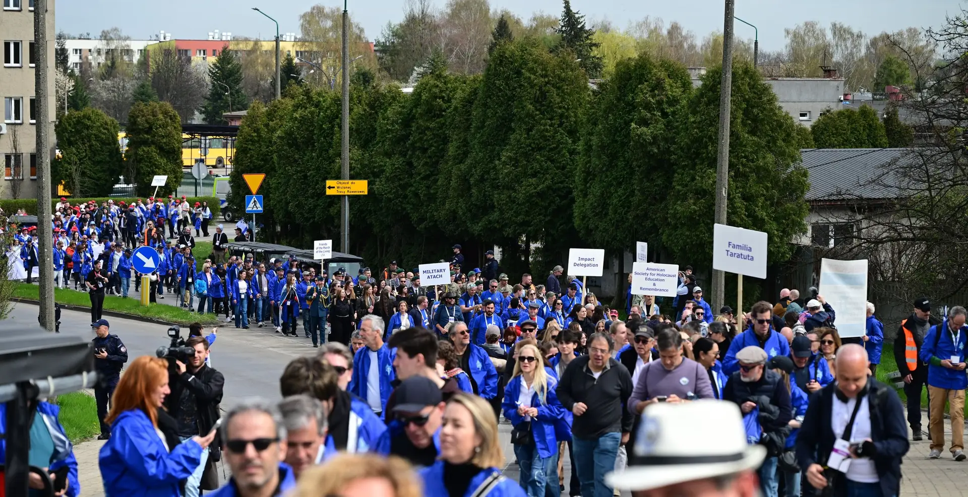 Marchers in blue March of the Living jackets walking from Auschwitz to Birkenau