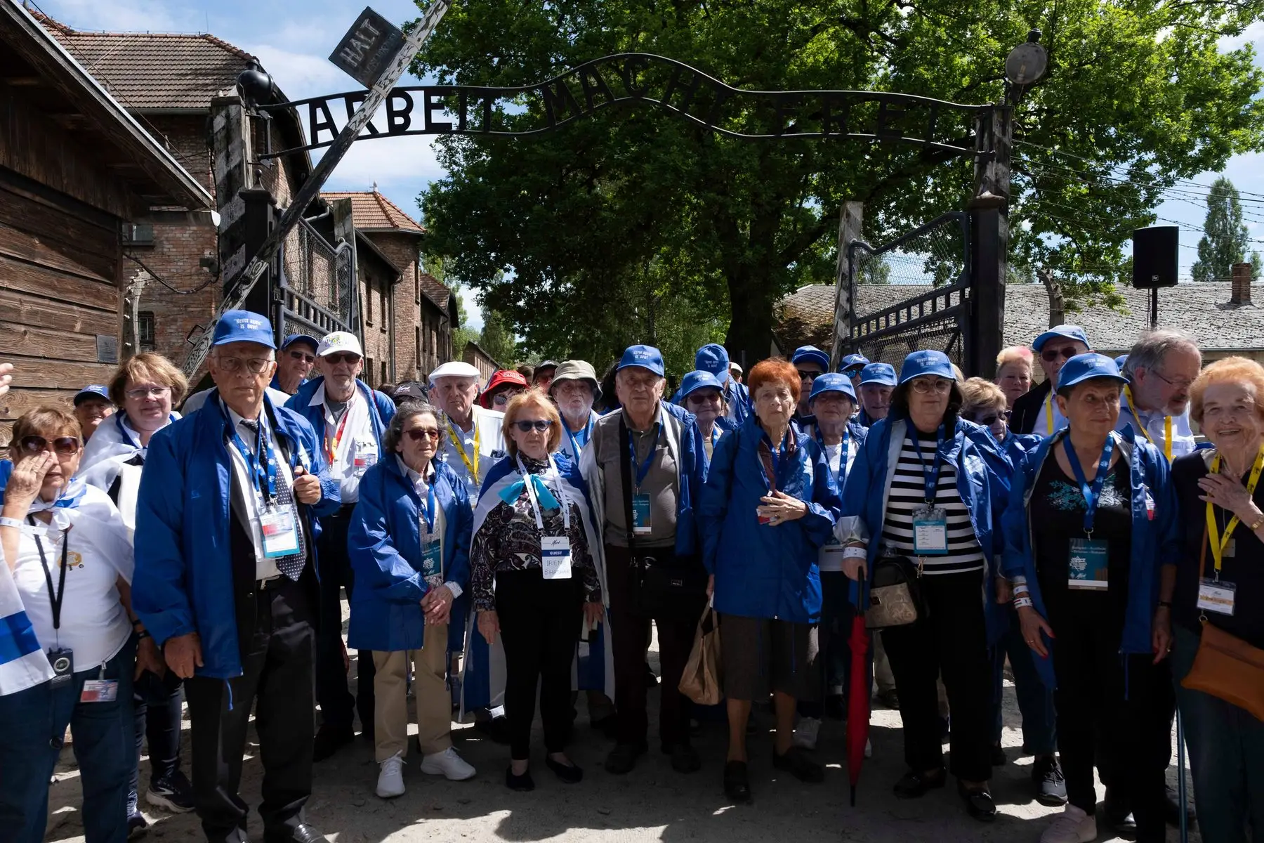 Holocaust survivors gathered beneath the Auschwitz gate at the 2024 March of the Living