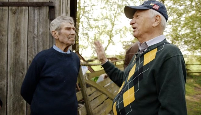 Sidney Zoltak talking with Zygmunt Krynski outside the barn