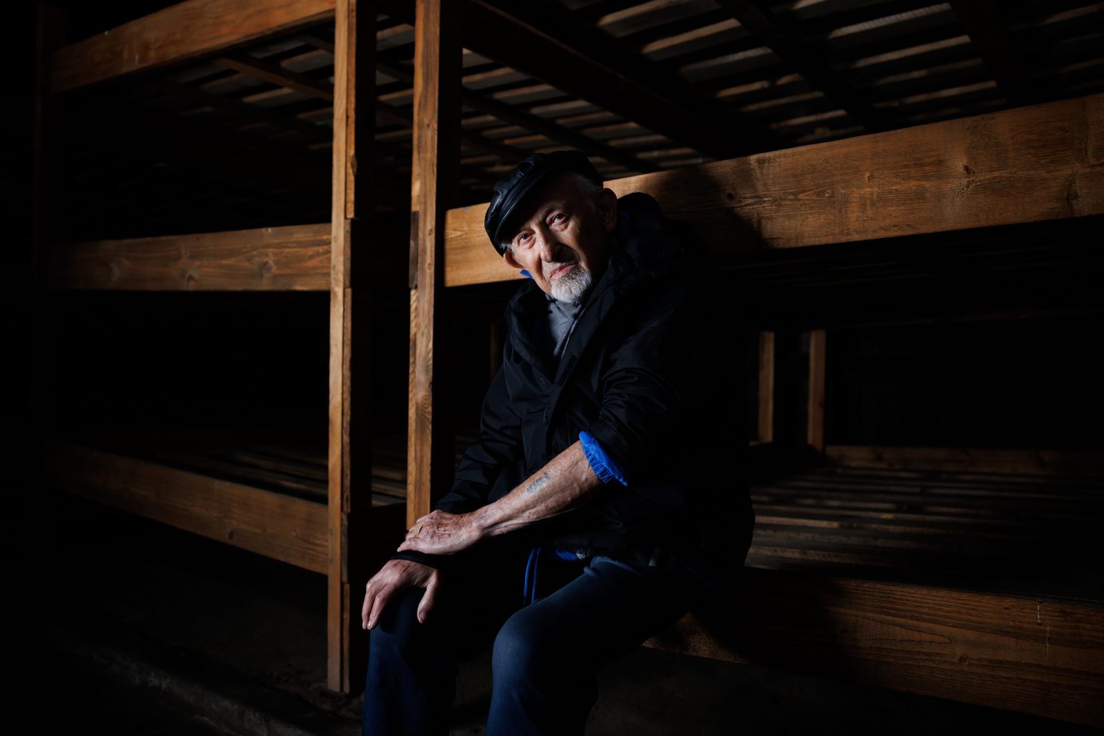 Nate Leipciger seated in the barrack where he was held in Birkenau