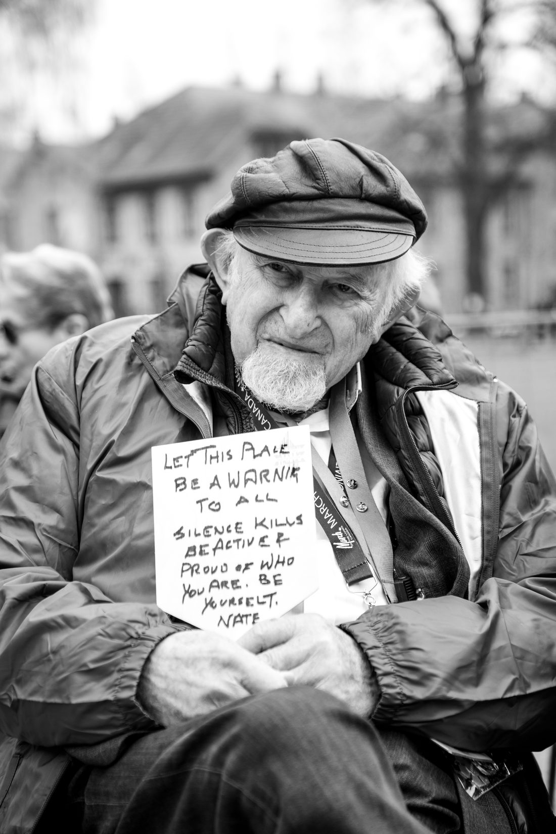 Nate Leipciger on the 2026 March of the Living, holding a handwritten sign